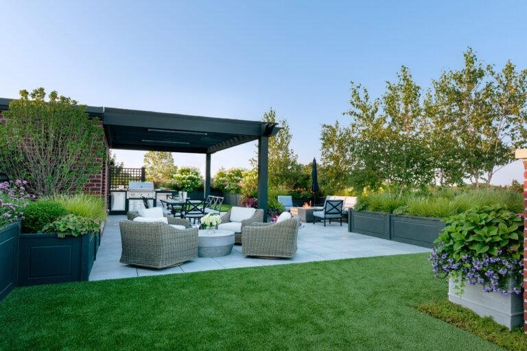 a modern home with a sophisticated terrace on a lush green lawn