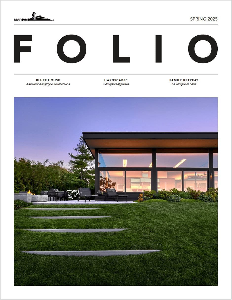 Modern house with large glass windows and flat roof at sunset, surrounded by green lawn and landscaped garden, featured on the cover of a magazine titled "FOLIO" Spring 2025 issue.